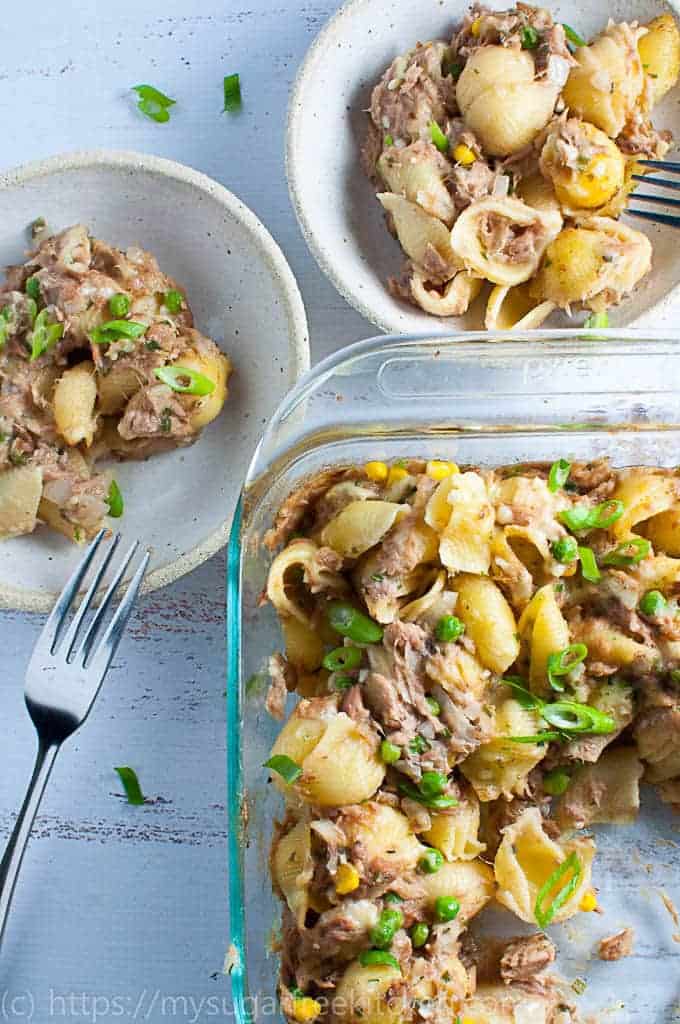 Serving up tuna mornay pasta bake into two bowls ready for dinner.