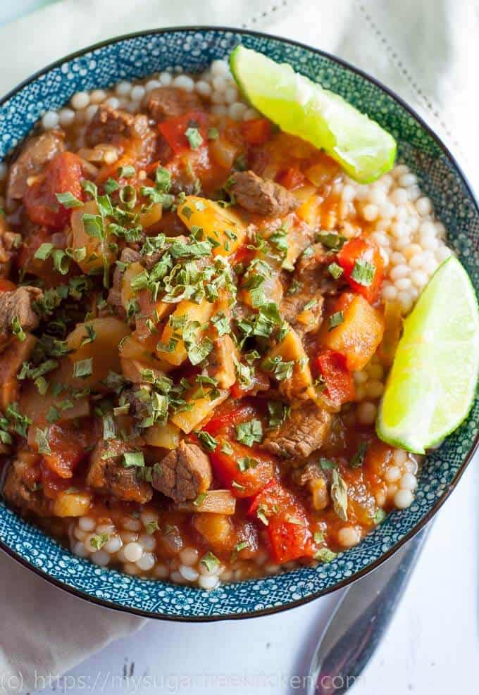 Slow cooked moroccan beef stew served with lime wedges