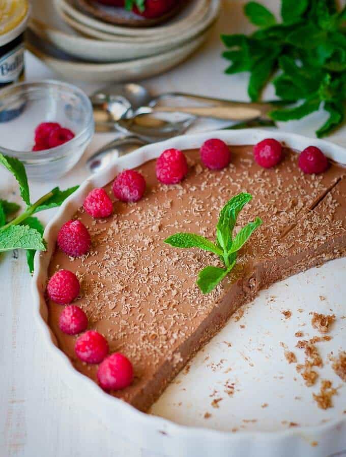 Half a chilli chocolate chocolate cheesecake with raspberries on top